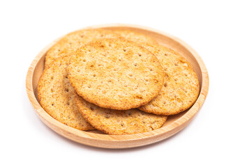 Baked round cracker chips in wooden dish isolated on white background with clipping path