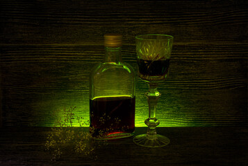 Glass on a dark background on a wooden table. Alcoholic drink.