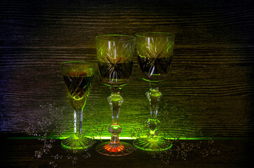 Glass on a dark background on a wooden table. Alcoholic drink.
