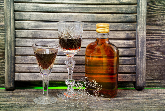 Glass on a dark background on a wooden table. Alcoholic drink.