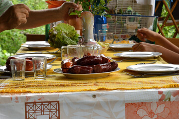 Table with toasted sausage, vegetables and mustard typical food in the village