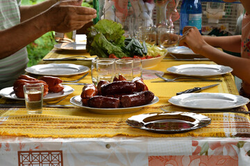 Family dinner at the cottage with toasted sausage and vegetables and mustard