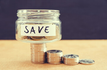 Coins in a glass jar for saving money financial concept