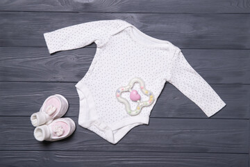 Baby clothes on a gray background. Place for text. Flat lay