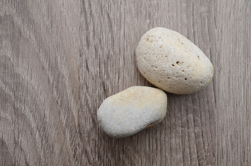 Fototapeta na wymiar two stones of rock on wooden
