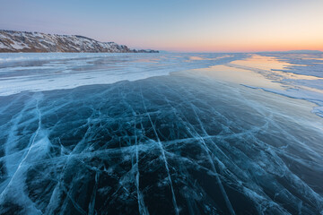 Colorful sunset over the crystal ice of Baikal lake