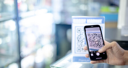 Male hand holding smartphone scan Qr code payment for digital pay without money cash, and get the...