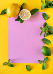 Fresh mint leaves on yellow background. Ingredients for mojito. Lemon, mint, lime.