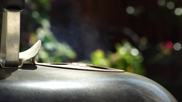 Smoke coming out of the top of a barbecue