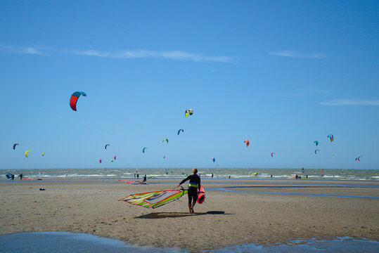 Kitesurfers at sea enjoying the wind on a sunny and beautiful day 