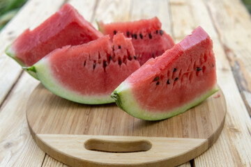 Fresh ripe sliced watermelon on wooden rustic background