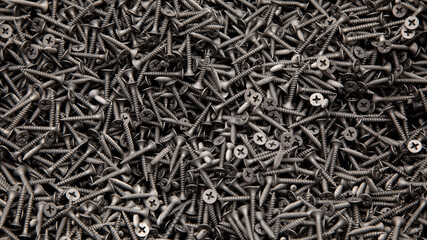 black screws are sold by weight, a background of black screws for advertising building stores