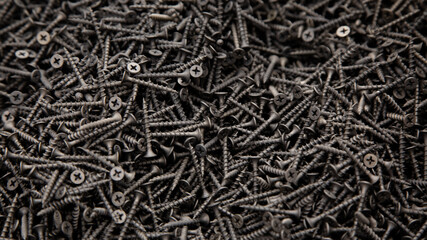 black screws are sold by weight, a background of black screws for advertising building stores
