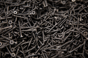 black screws are sold by weight, a background of black screws for advertising building stores