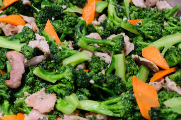 The hot stir fried broccoli, carrot with giant pork (close up) - food concept.