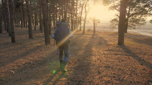 concept sciatic rheumatism back pain the medicine. man traveler tourist with a backpack pulled his back tired face pain. hiker concept travel difficulties tourism sunlight lifestyle sunset