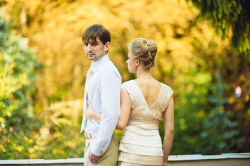 Happy bride and groom walking in the park on their wedding day