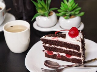Chocolate velvet cake served with hot tea 