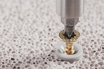 screwdriver screw and dowel in a concrete wall background