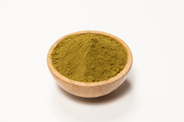 Henna powder in a wooden bowl. Natural hair care. Henna hair dye.