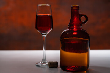 Decanter and glass of red wine on a counter