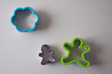 Cookie cutters in the form of an adult and a child with a cloud on a white background. Picture of a happy family. 