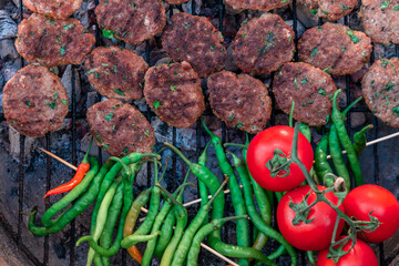 delicious meatball pepper tomato roasting on barbecue fire