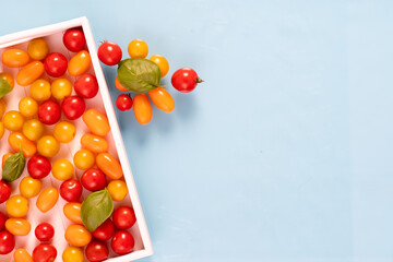 fresh italian cherry tomatoes on the vine in a wooden crate on a white background