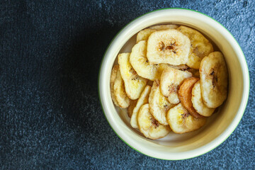 banana chips sweet and healthy snack Menu concept serving size. food background top view copy space for text organic healthy eating