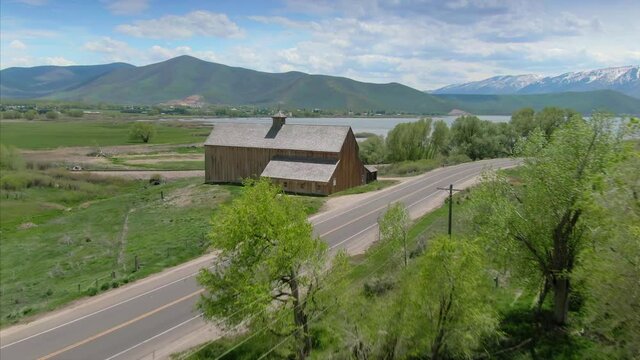 Aerial: Old Historic Tate Barn and highway. Midway, Utah, USA