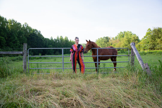 woman in colorful jumpsuit with brown horse 3
