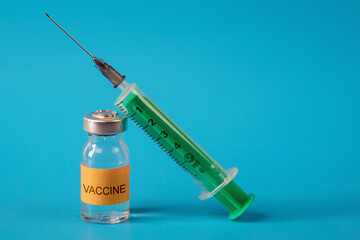 Medicine bottle for injection with medical vials for vaccination on the background on the blue...