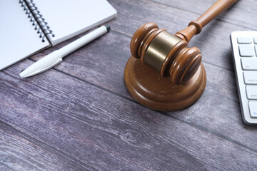 Top view of gavel, notepad and keyboard on table 