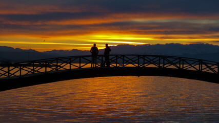 People watching the sunset on the bridge