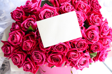 bouquet of red roses with blank card