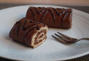 Chocolate cake rolls on a white plate