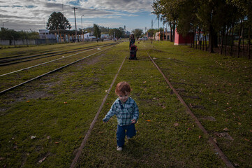 A two years old boy walks through abandoned railways in the city of Firmat, in the Santa Fe...