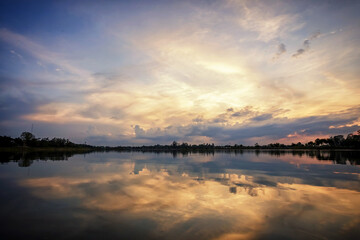 Obraz na płótnie Canvas sunset with grass on the lake