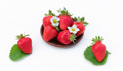 wooden dish with strawberries. white background.