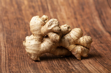 a ginger root lying on a wooden background
