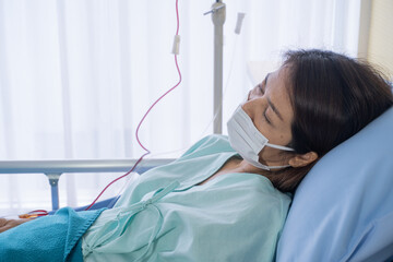 Asian woman is sick has a high fever, sneezing, is recuperating in the patient's dress lay on the...