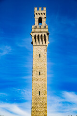 Fototapeta premium Pilgrim Monument isolated against a blue sky & Provincetown Museum. Provincetown, Massachusetts, USA. September 2019.
