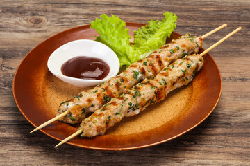 Minced pork skewer kebab with sauce
