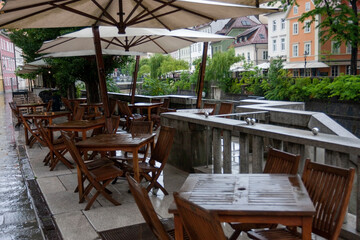 Fototapeta na wymiar summer terrace of a small cozy restaurant near the river during rains