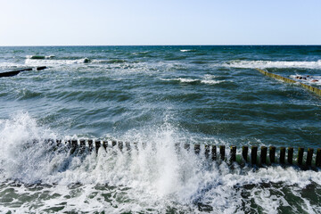 splashing waves of Baltic Sea, waves braking through cutwater 