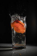 Glass of cold drink with orange