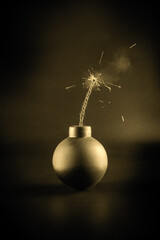 A bomb with a lit fuse on a dark background. Explosion hazard.