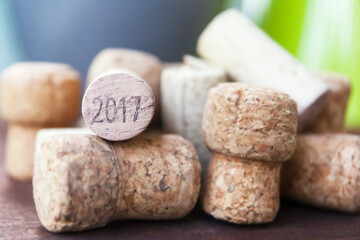 heap of wine corks on wooden table, wine cork 2017 vintage