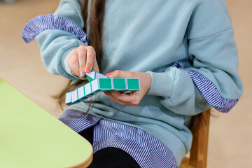 Child's hands playing with plastic bricks