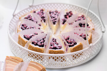 Delicious sweets on candy bar. Cheesecake with bilberry